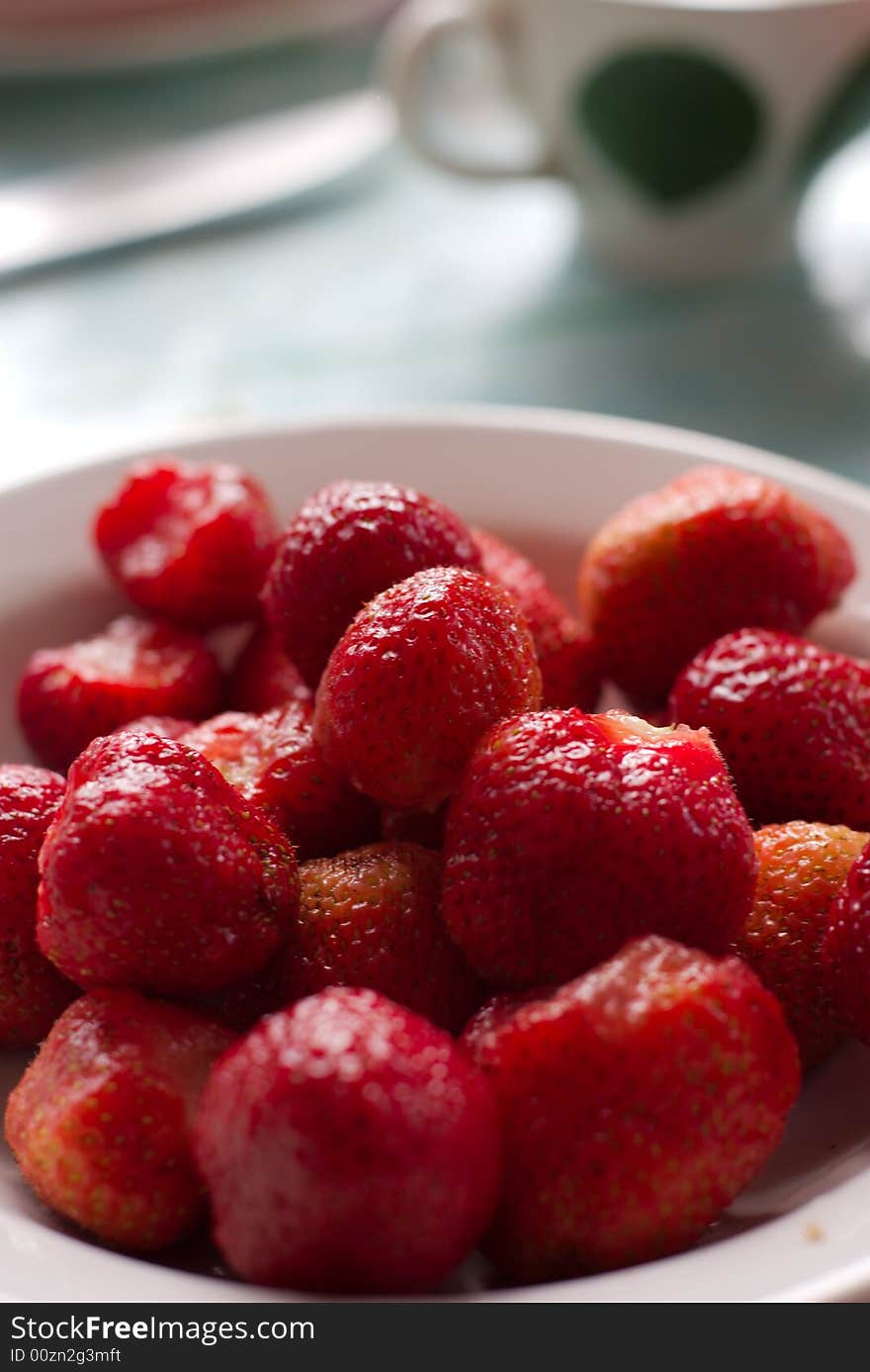 Ripe strawberry in a plate on a table