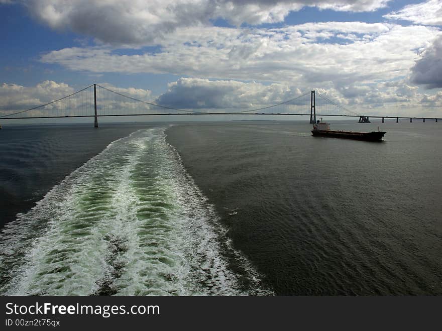 Cargo ship, having just passed under a bridge