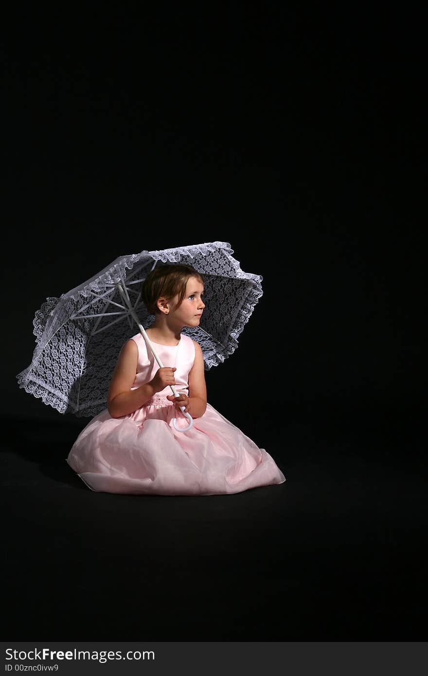 Pretty girl in a pink dress holding a white lace parasol. Pretty girl in a pink dress holding a white lace parasol