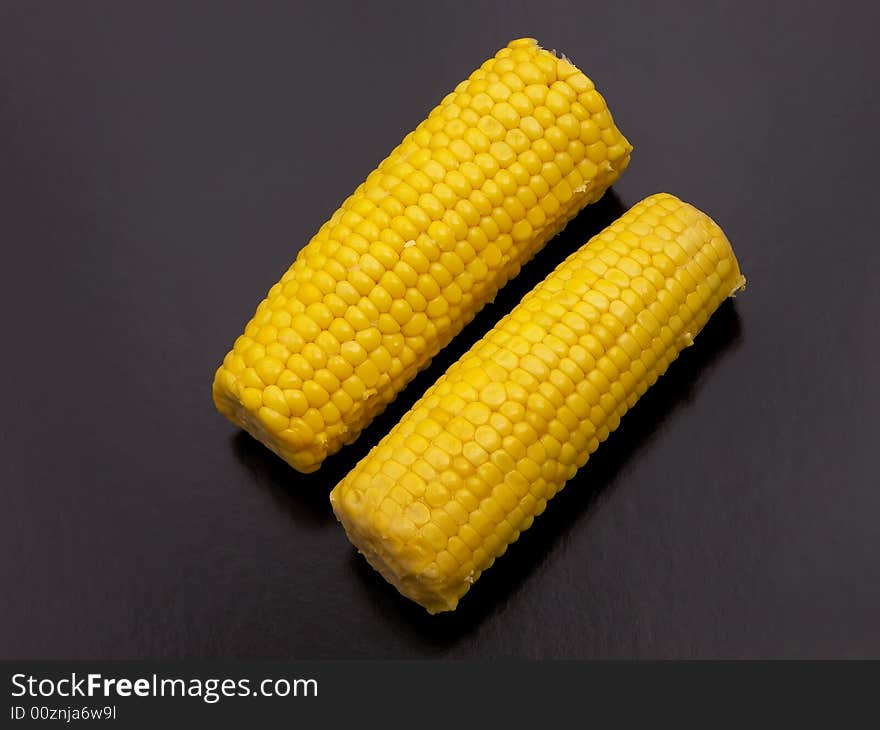 Two sweet corn on the cob.