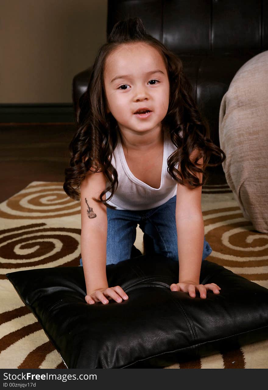 Young Beautiful hispanic Girl Playing in livingroom. Young Beautiful hispanic Girl Playing in livingroom