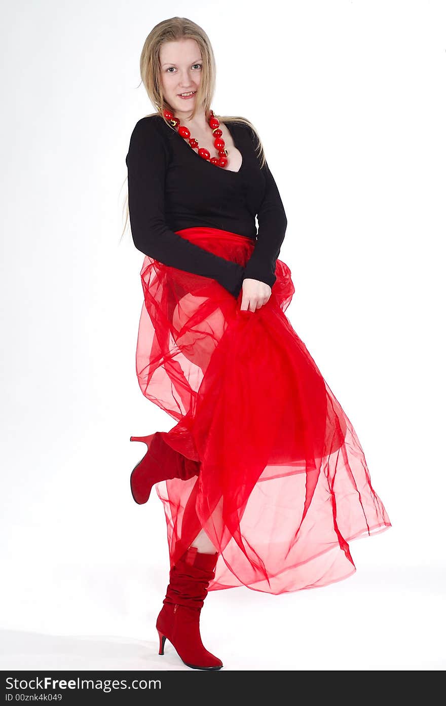 Young girl wearing red transparent skirt, high boots and beads