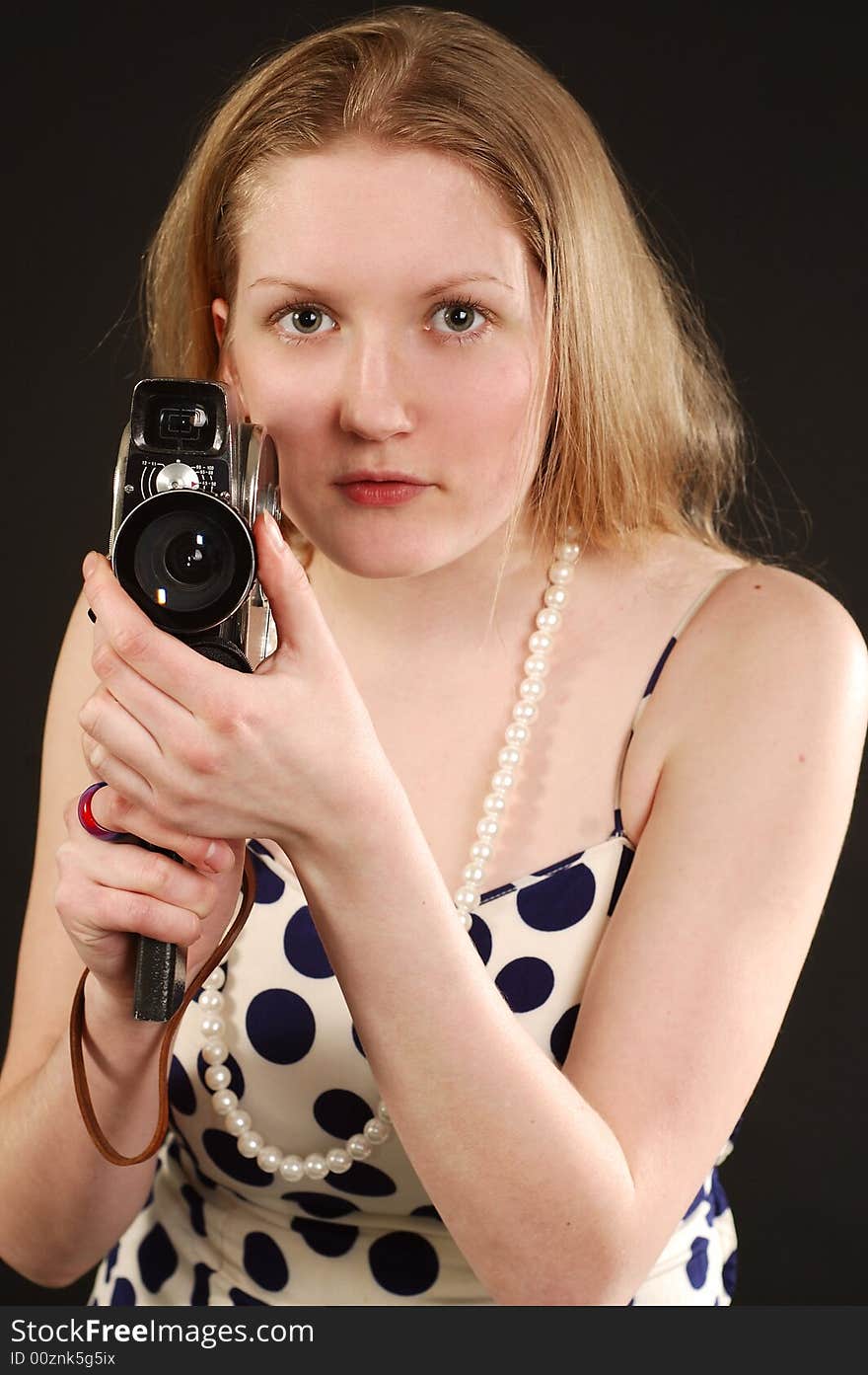 Girl holding a vintage movie camera