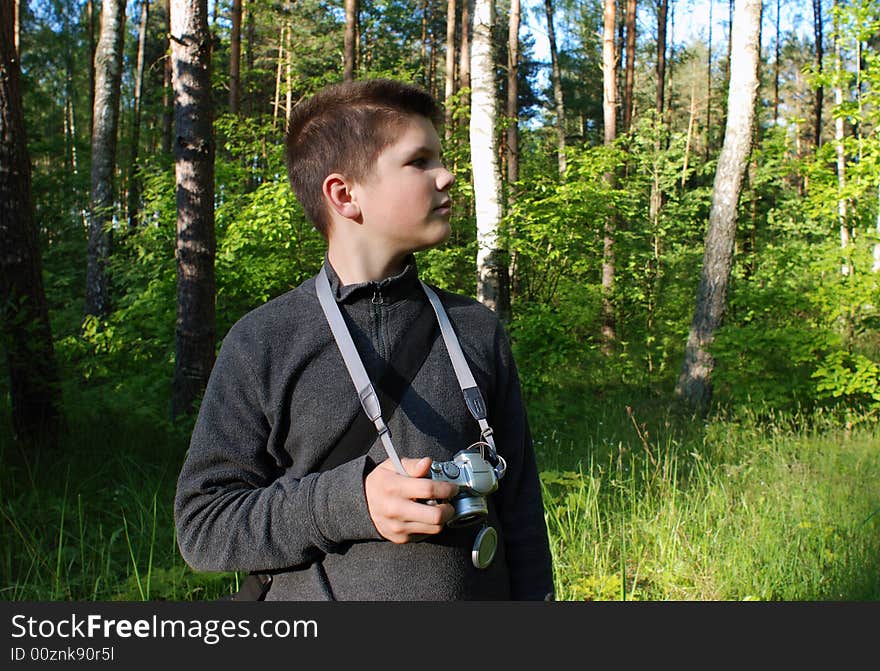 The young photo enthusiast in Lithuanian forest. The young photo enthusiast in Lithuanian forest.