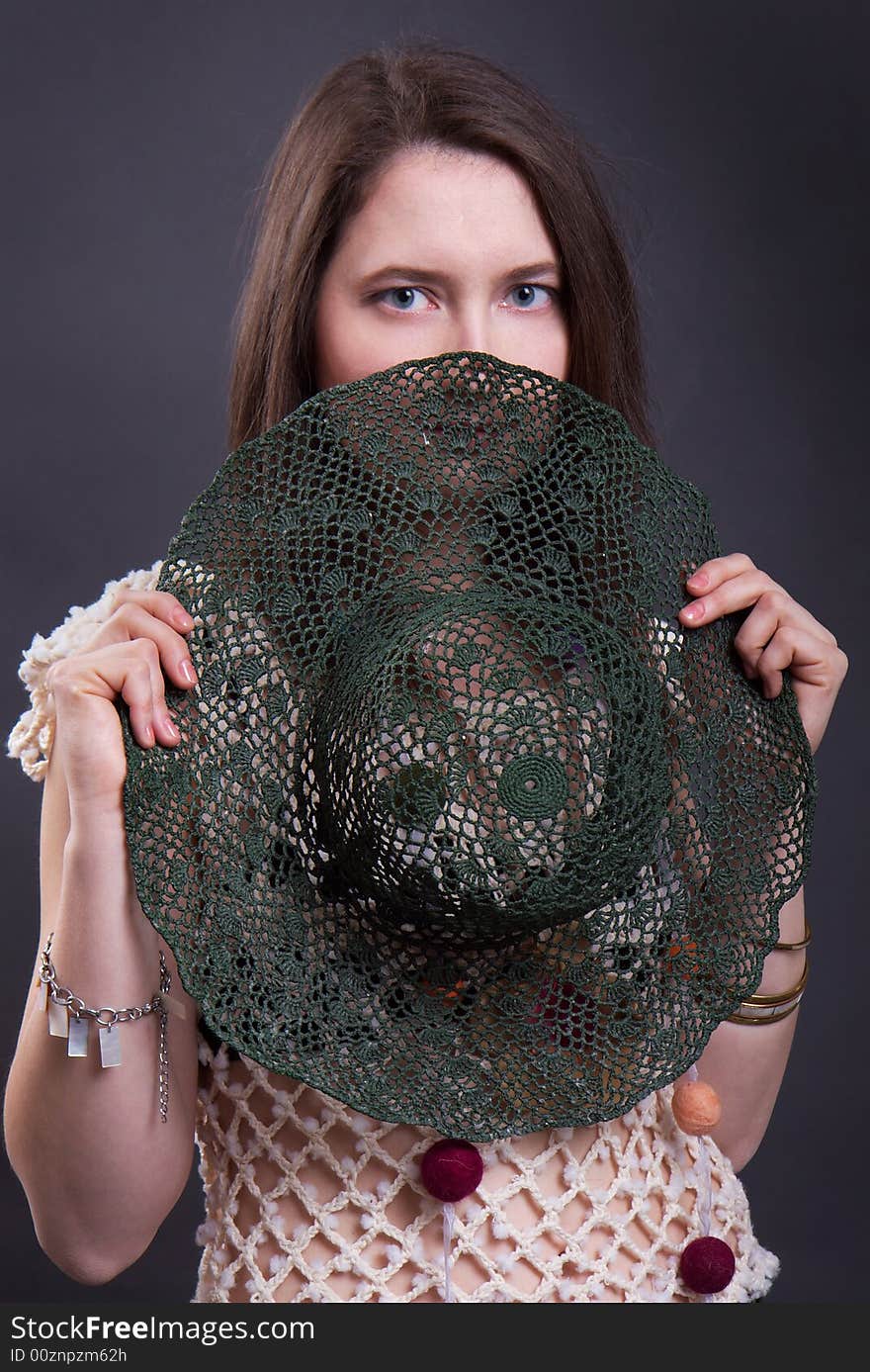 The young woman in summer clothes with a green hat