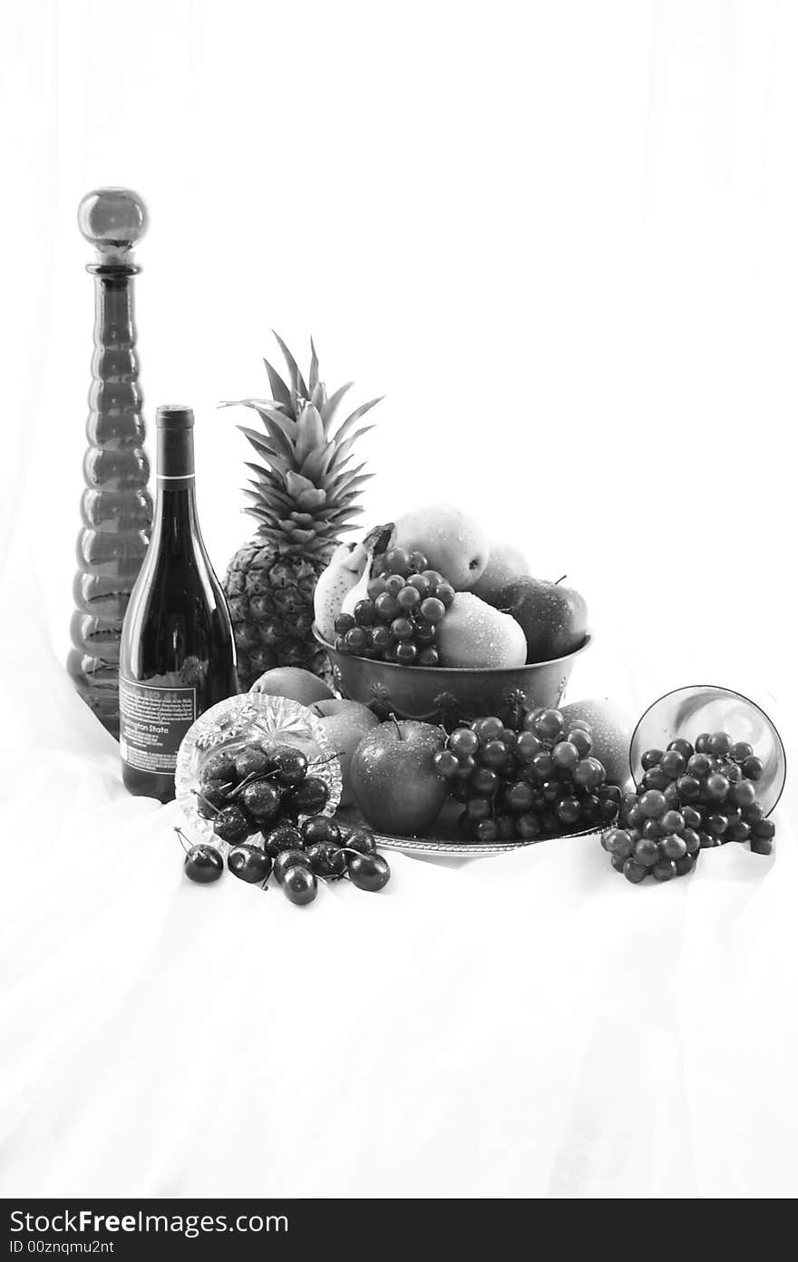 Black and white high key image of wine and fruit bowl. Black and white high key image of wine and fruit bowl.