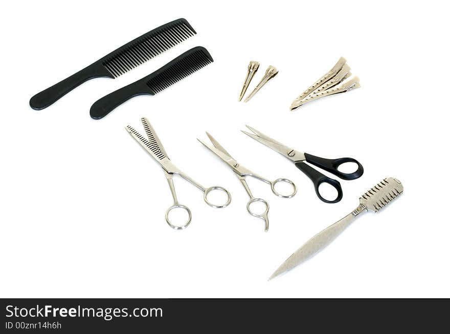 Set of pair of scissors and combs for hairdo on white background, studio shot. Set of pair of scissors and combs for hairdo on white background, studio shot