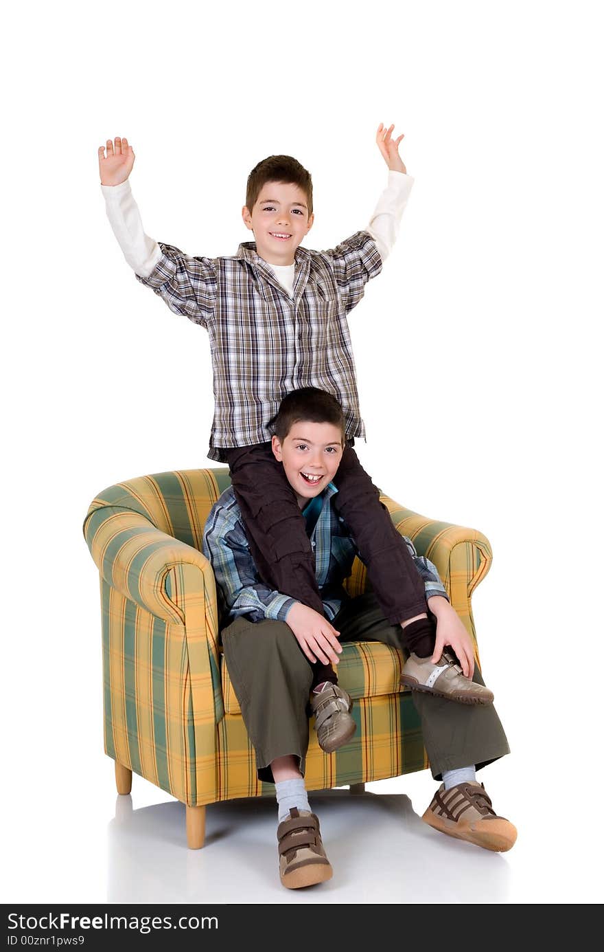 Two young happy smiling boys playing in the chair. Two young happy smiling boys playing in the chair