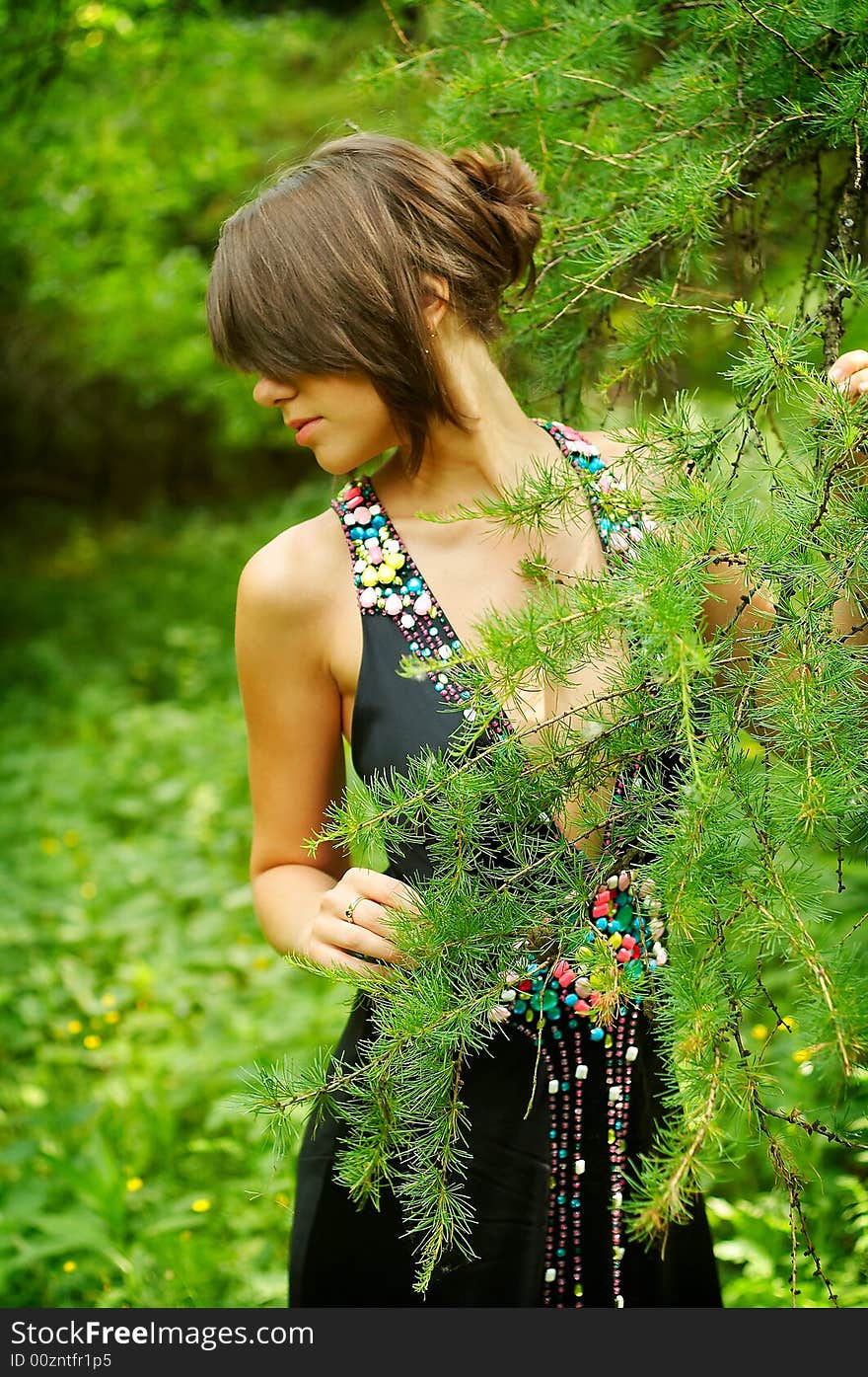 Young girl in black dress in the woods