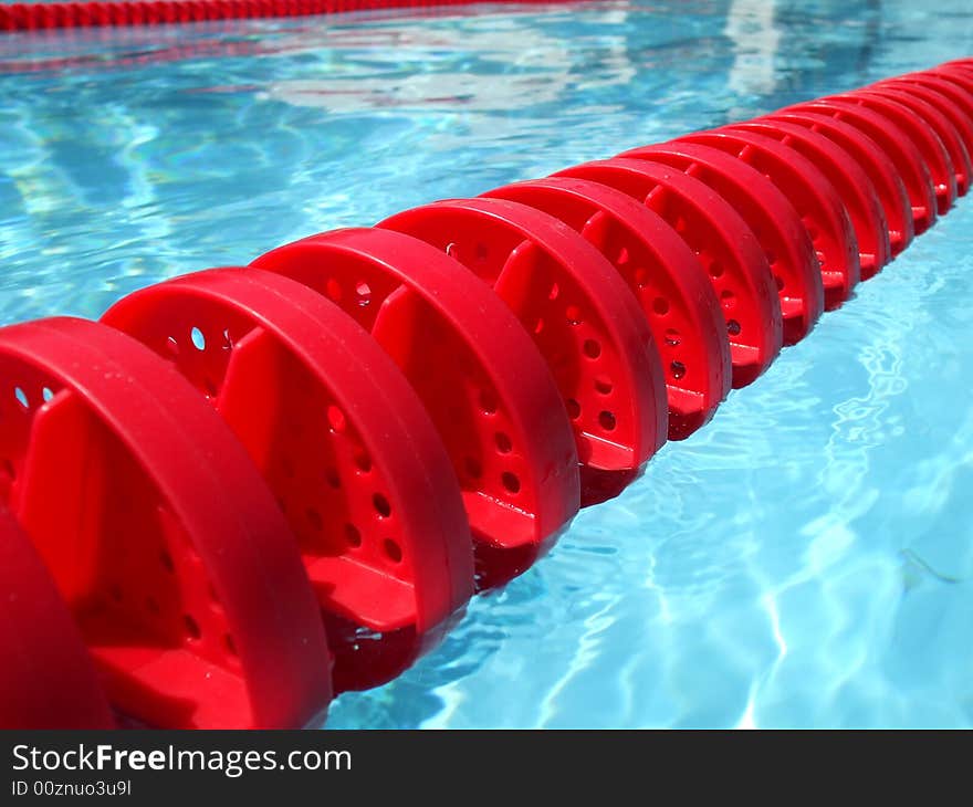 Photo of swimming pool lane divider during summer.