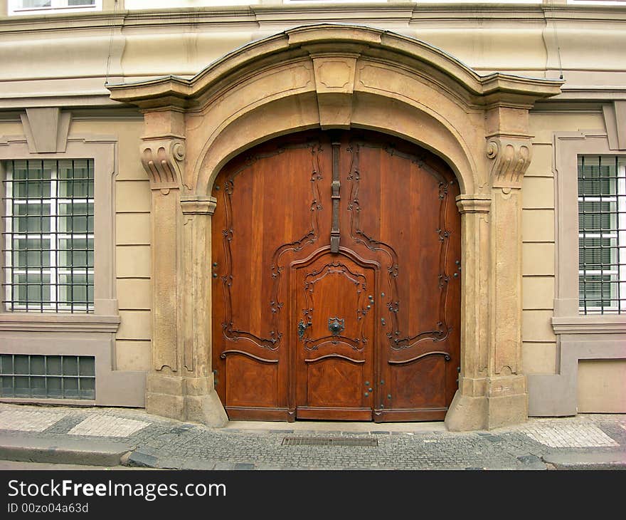 Old wooden portal of  in Prague with two pillars on a side