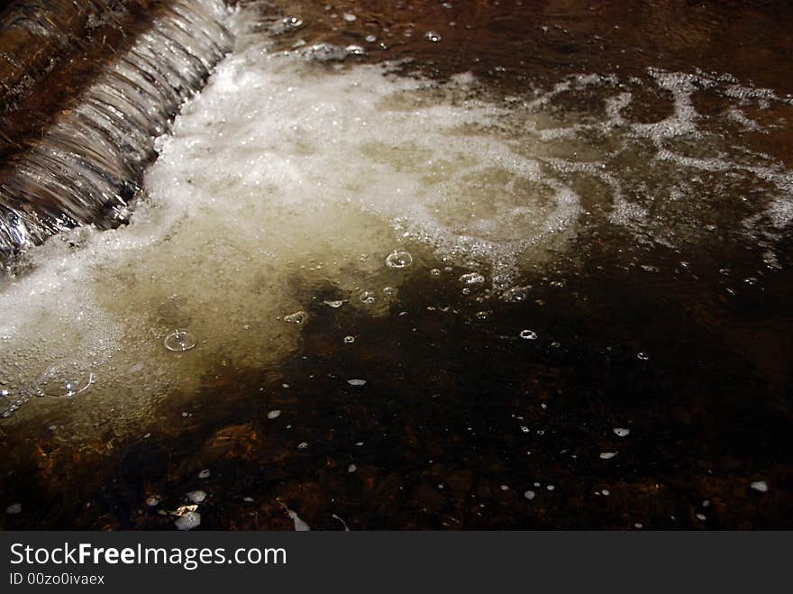 Detail of a brook with a small cascade. Detail of a brook with a small cascade