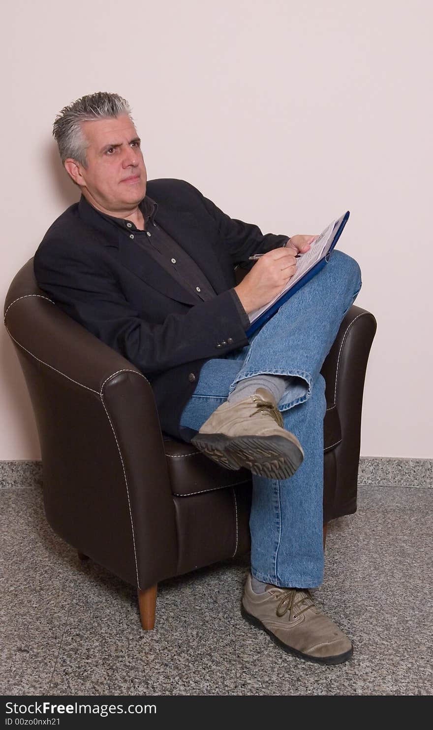 A business man writing a report in while in his study