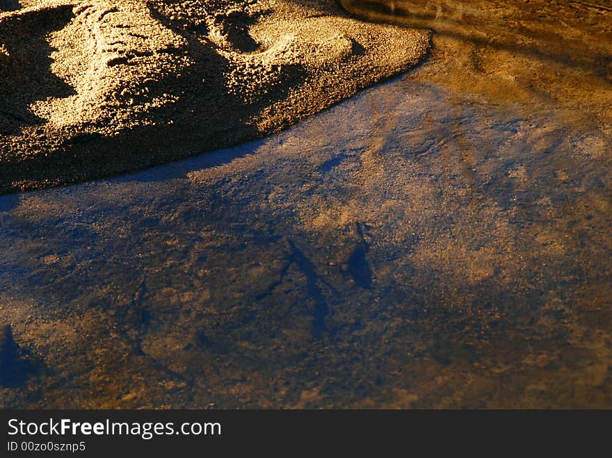 Still and transparent water of a brook with a beach. Still and transparent water of a brook with a beach