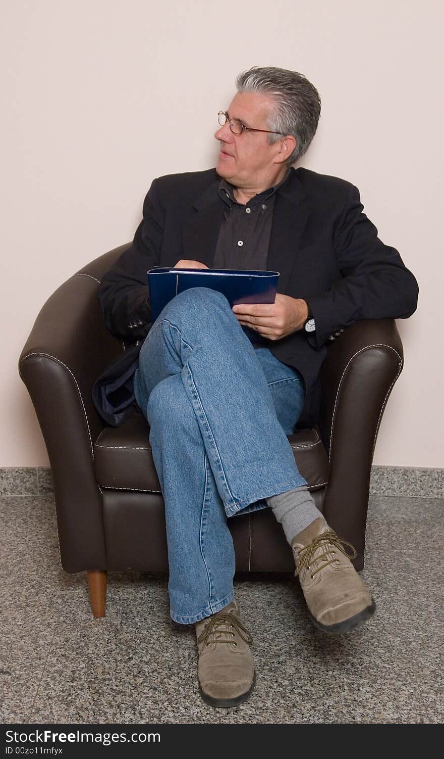 A business man writing a report in while in his study