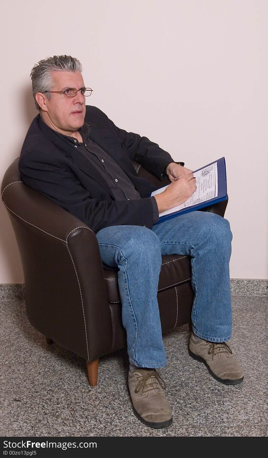 A business man writing a report in while in his study