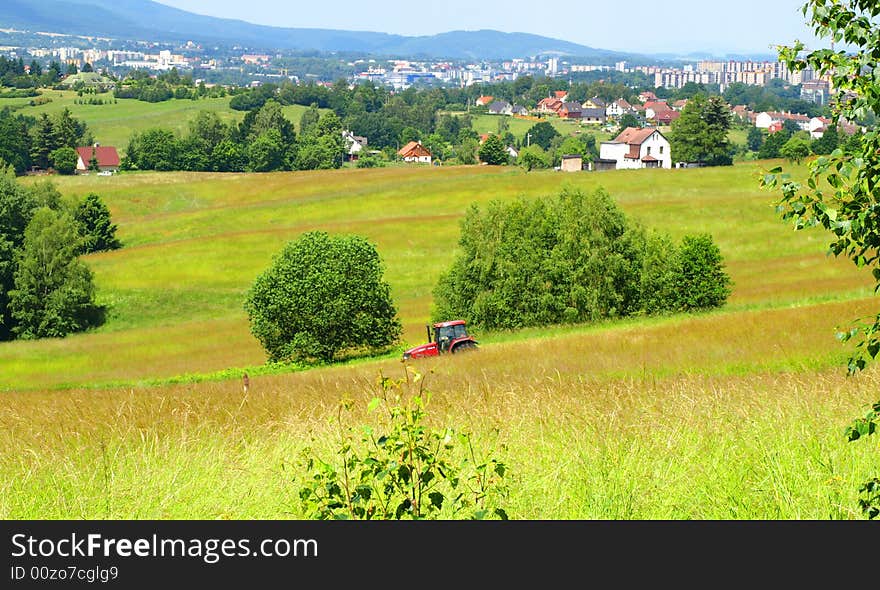 Privacy farmer mowing grass. The farm is located near the city. Privacy farmer mowing grass. The farm is located near the city.