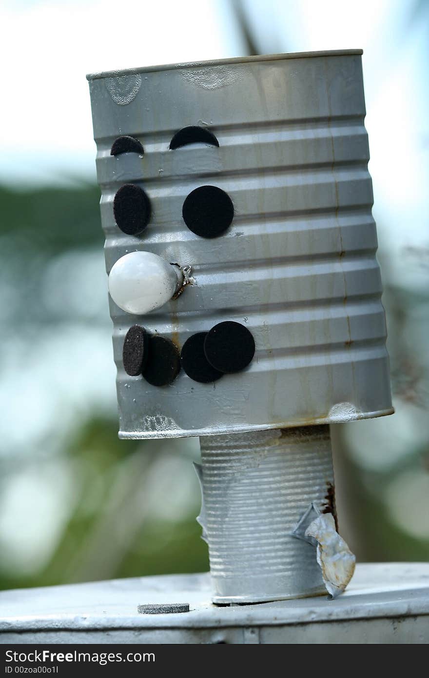 A tin man built for fun in a garden.