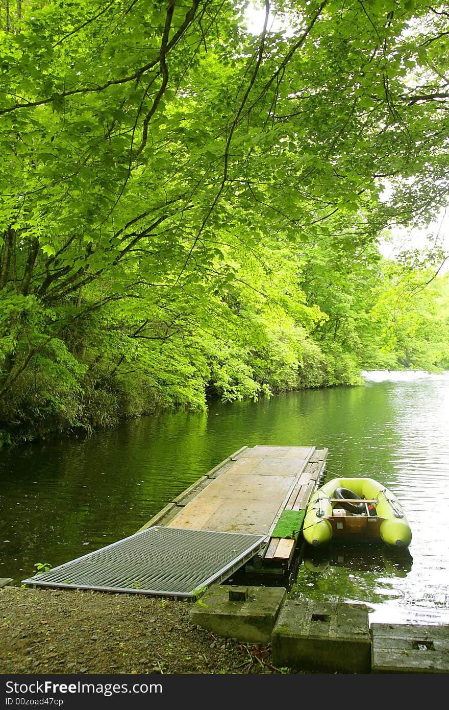 A green smal boat near pier. A green smal boat near pier