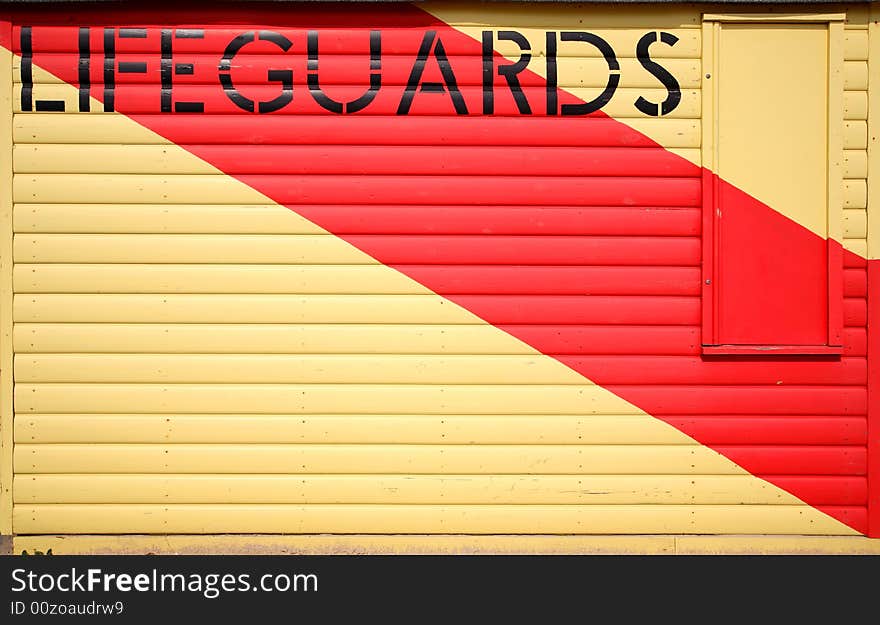 Wooden lifeguards hut with painted stripe