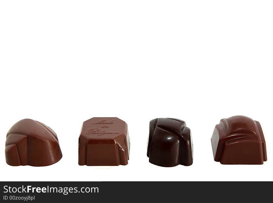 Four luxury chocolates in a row on white background. Four luxury chocolates in a row on white background
