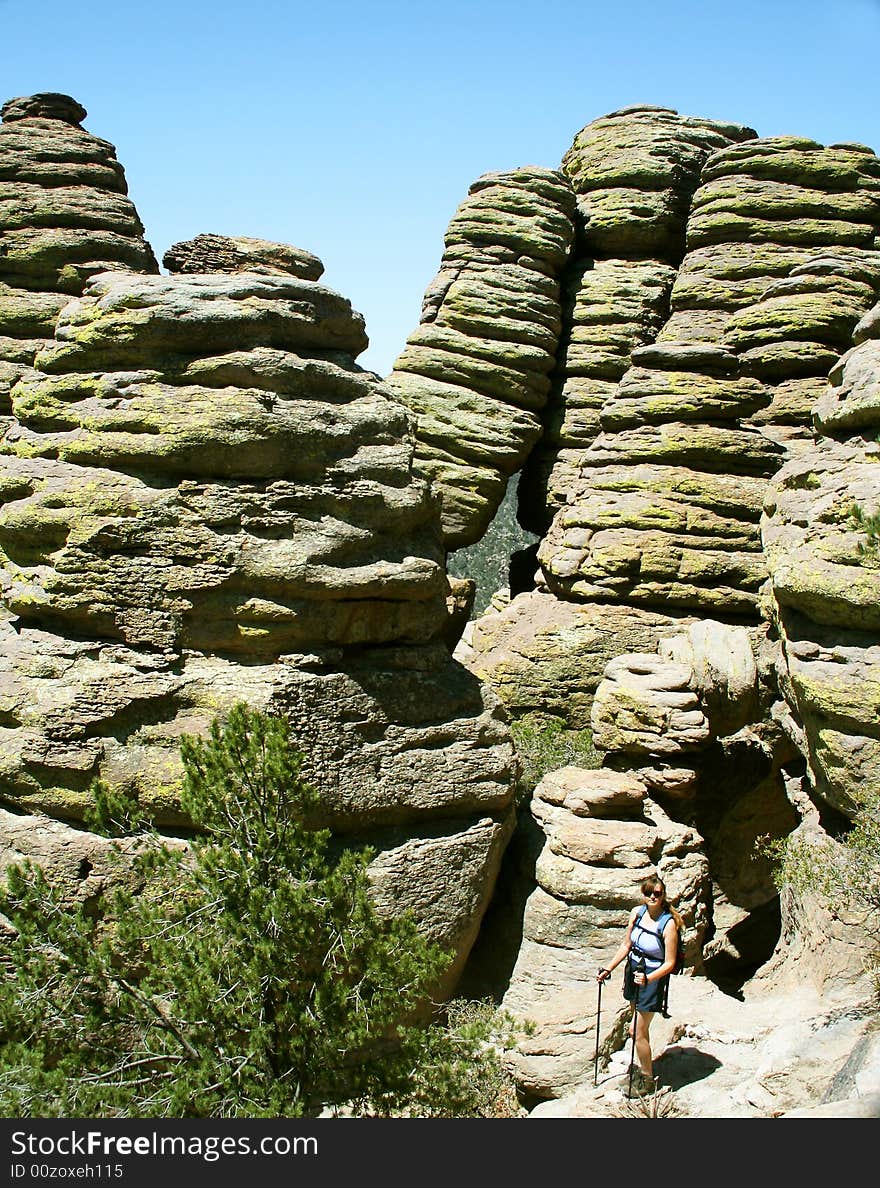 A Woman on a Hike Pauses Amongst the Weird Pinnacles Called 'Standing Up Rocks' Along the Echo Canyon Trail, Chiricahua National Monument, Arizona. A Woman on a Hike Pauses Amongst the Weird Pinnacles Called 'Standing Up Rocks' Along the Echo Canyon Trail, Chiricahua National Monument, Arizona