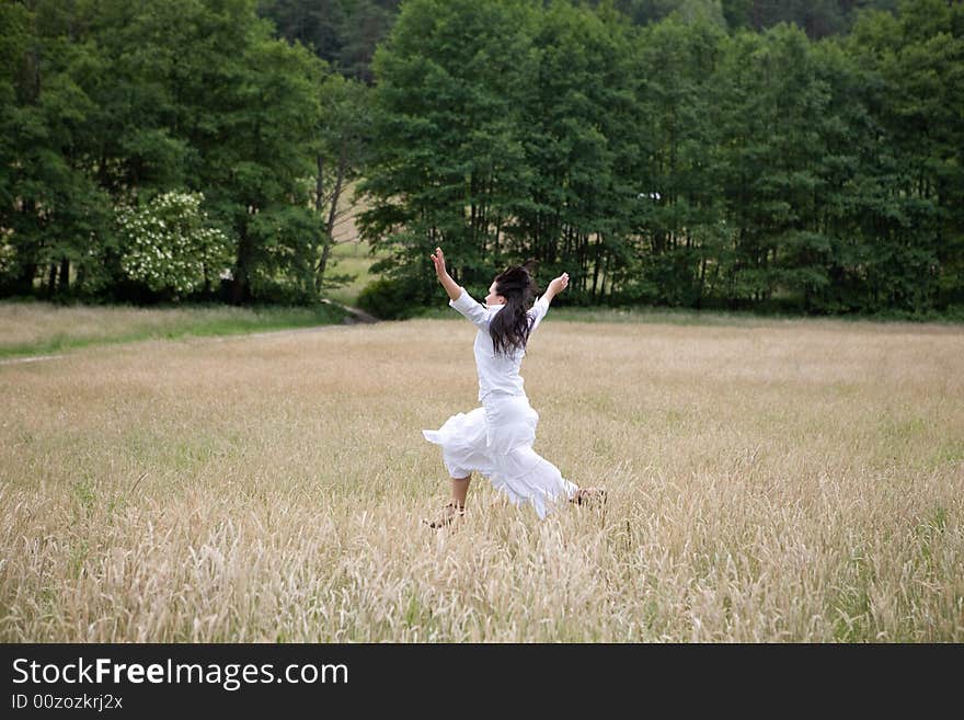 Happy woman jumping on green meadow. Happy woman jumping on green meadow