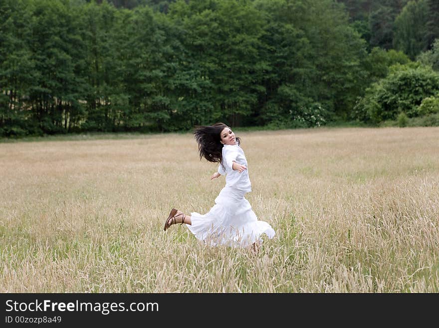 Happy woman jumping on green meadow. Happy woman jumping on green meadow