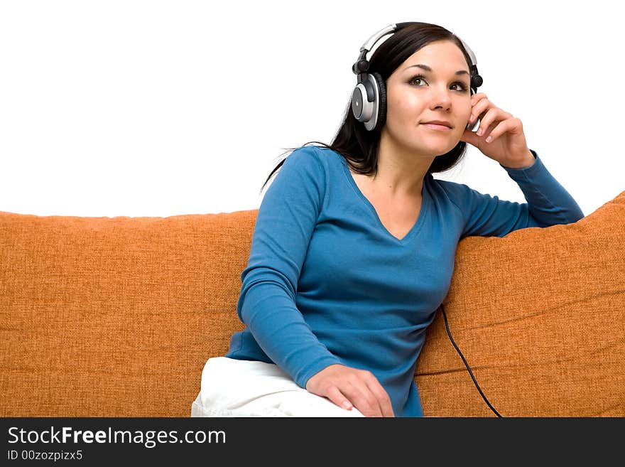 Attractive woman with headphones on sofa. Attractive woman with headphones on sofa