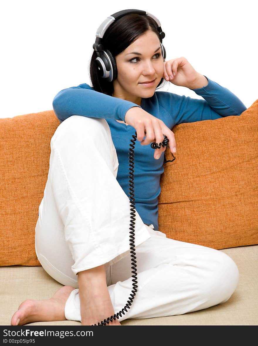 Attractive woman with headphones on sofa. Attractive woman with headphones on sofa