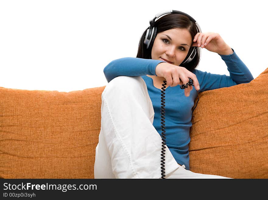 Attractive woman with headphones on sofa. Attractive woman with headphones on sofa