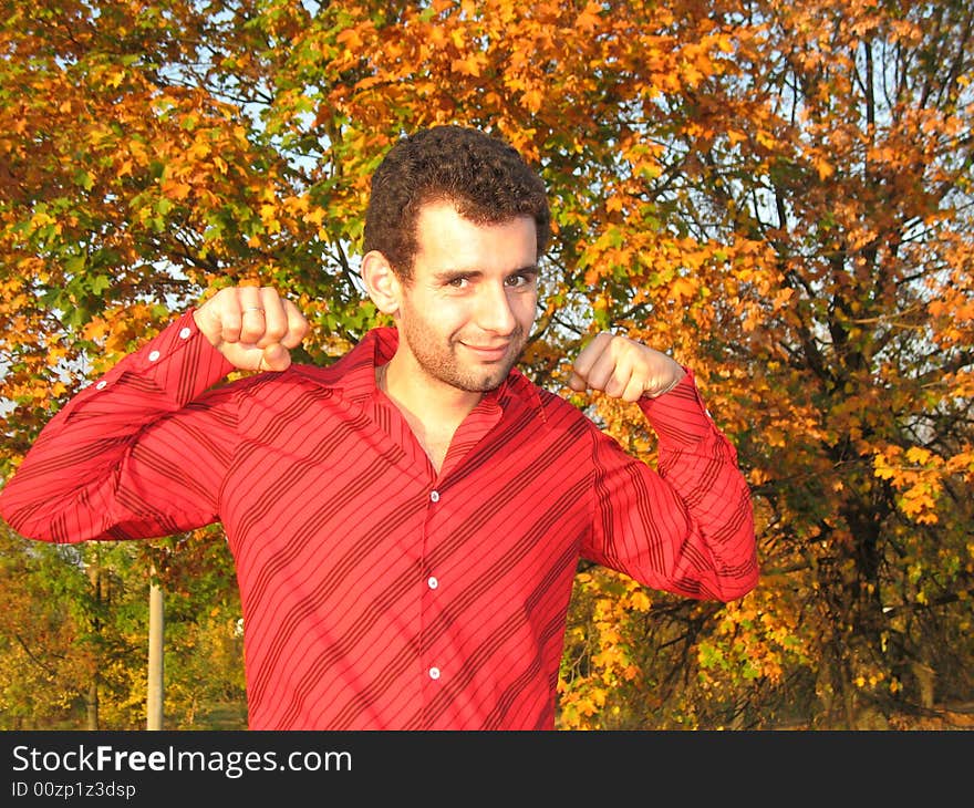 The young man is exercising in the park. The young man is exercising in the park