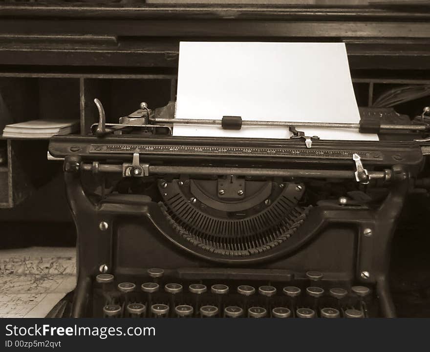 Sepia toned image of old typewriter and desk