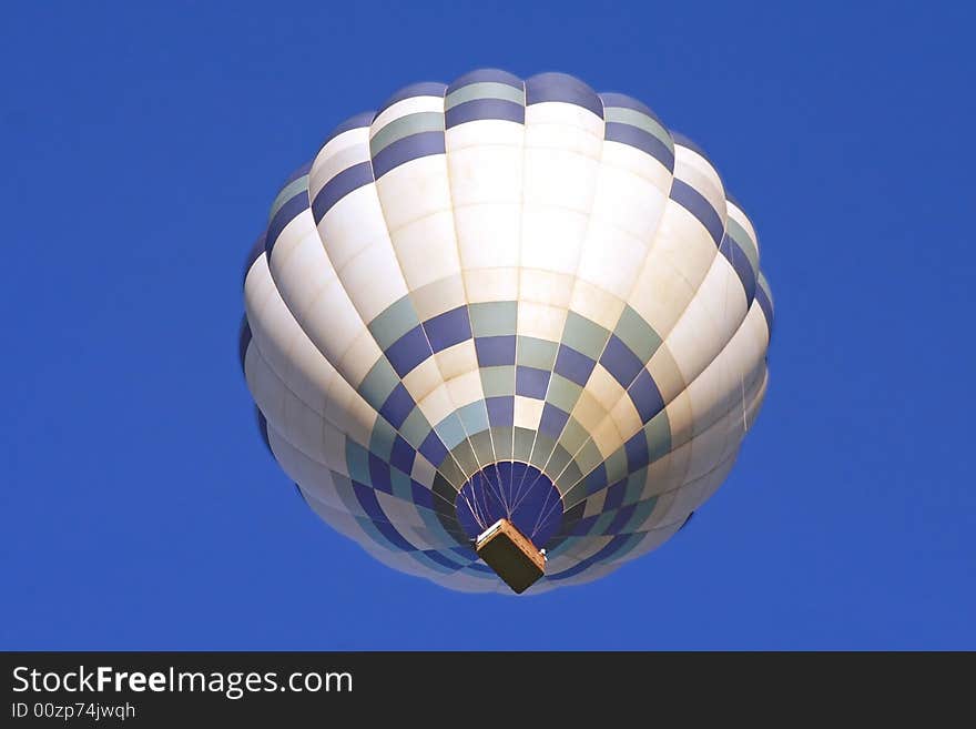 A Hot Air Balloon on an clear morning flight.  Space for copy.