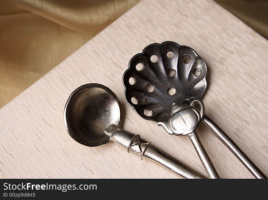 Silver spoons on a cream coloured box background