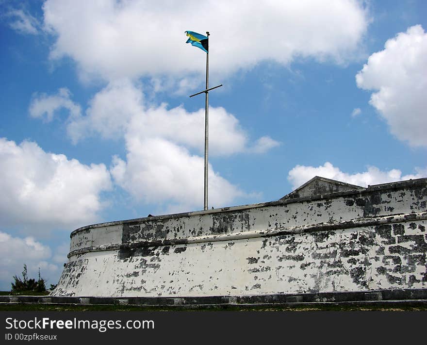 The Bahamian flag and Charlotte Fort in Nassau town, the capital of The Bahamas.