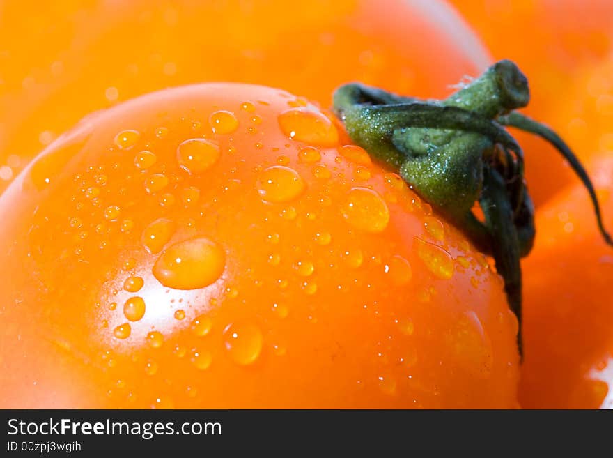 Closeup macro tomato with green shank