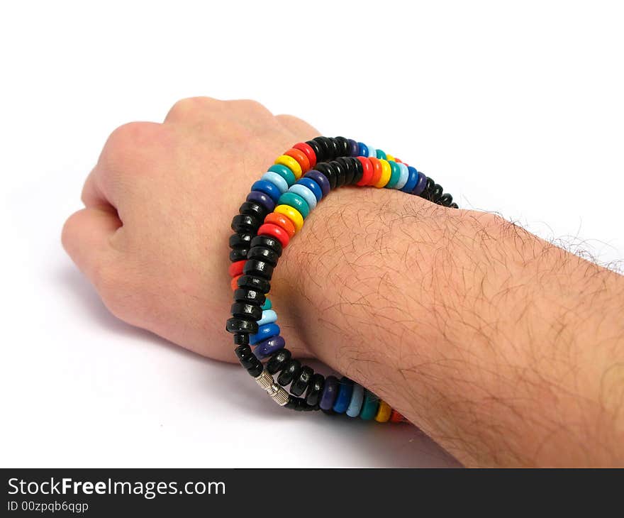 Painted wood necklace on a hand, in a white background. Painted wood necklace on a hand, in a white background