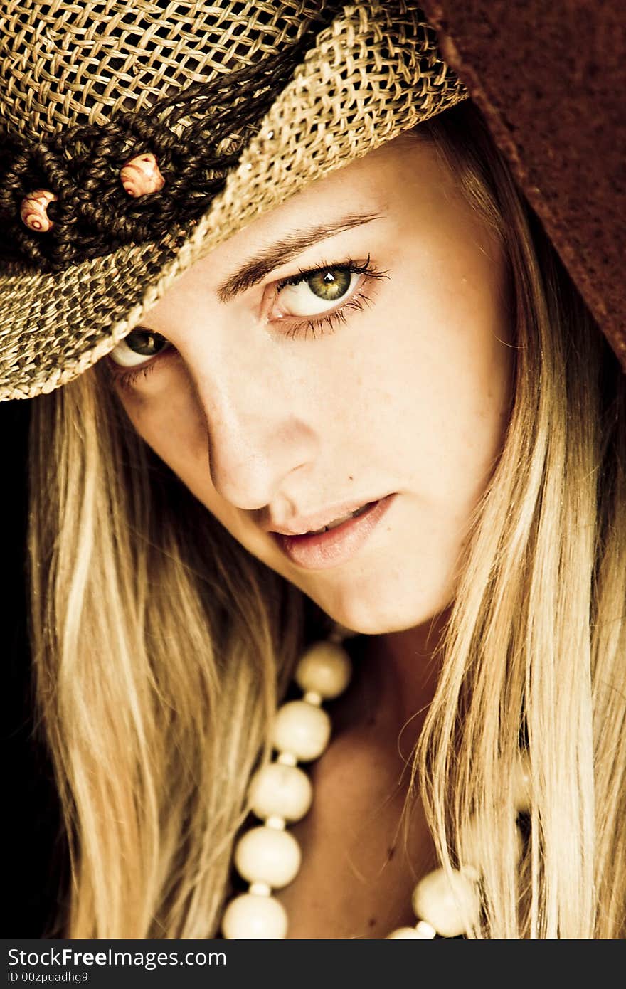 Young blond woman with hat.