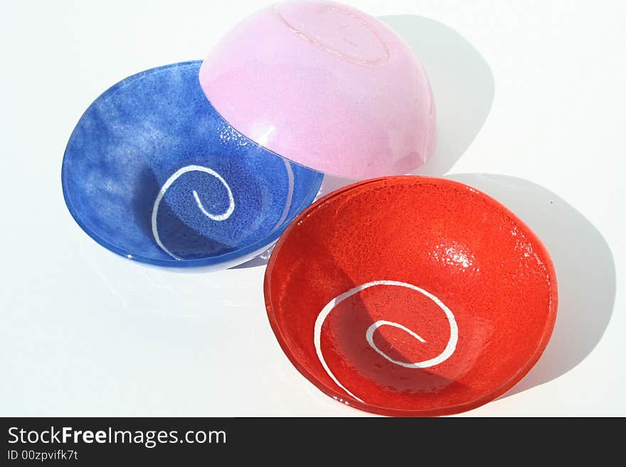 Three colorful bowls on a
white backround.