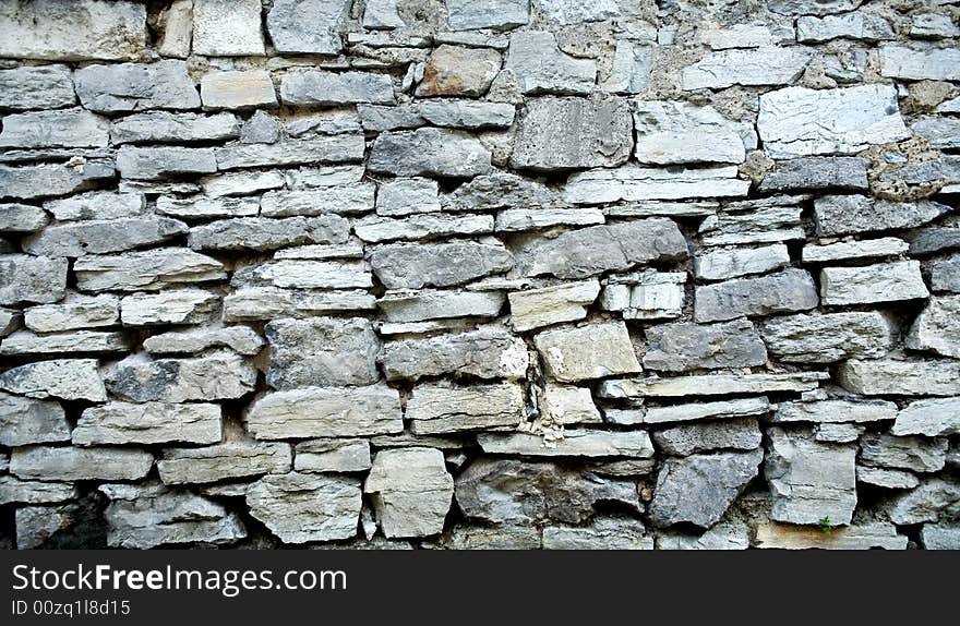 An image of grey stone wall. Close up. An image of grey stone wall. Close up.