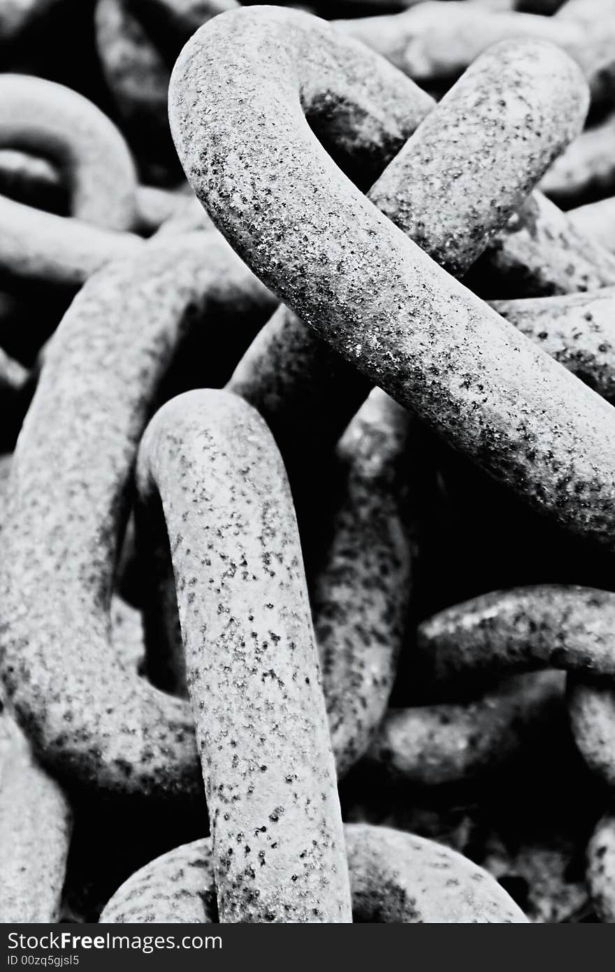 B&W old rusty chain close up laying on the beach