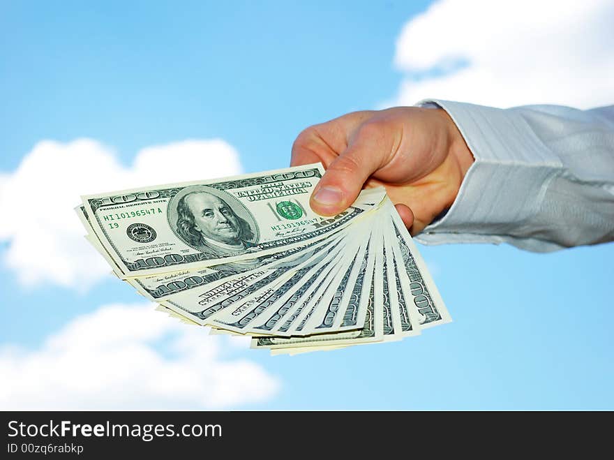 Money in hand  isolated on sky background