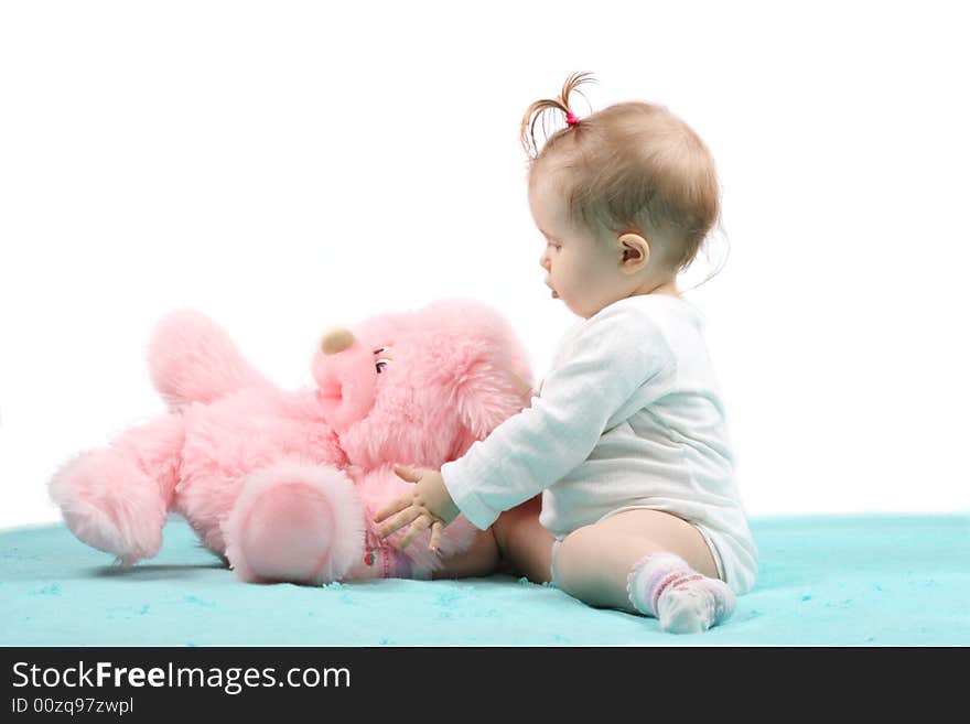 The small child with a pink toy. The small child with a pink toy