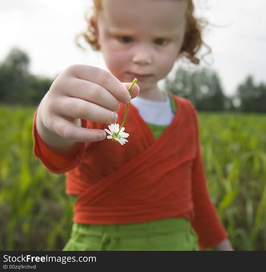 Little gilr holding flower