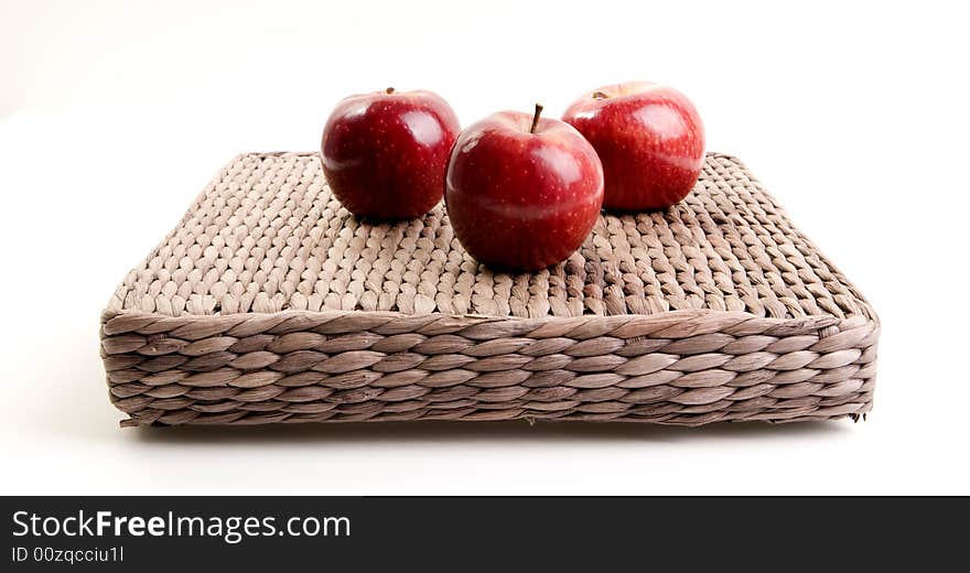 Three red apples on white background