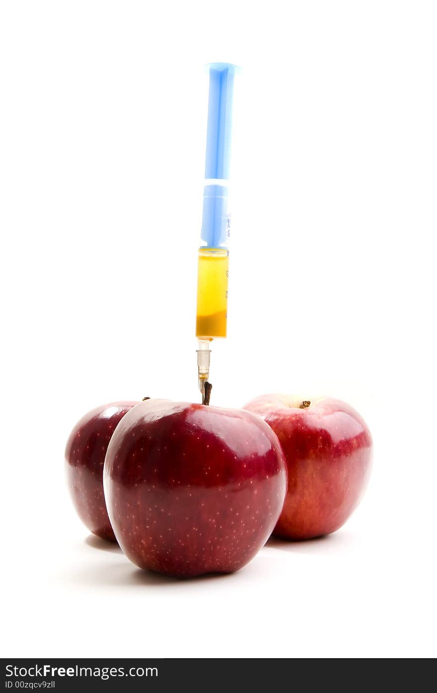 Red apples with syringe on white background. Red apples with syringe on white background