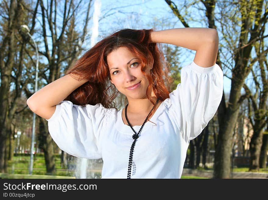 Attractive young girl relaxing outdoors. Attractive young girl relaxing outdoors