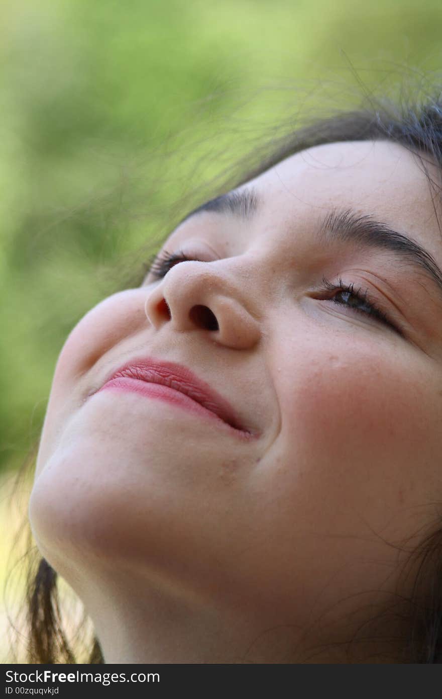 Young teen girl daydreaming looking up sky smiling. Young teen girl daydreaming looking up sky smiling