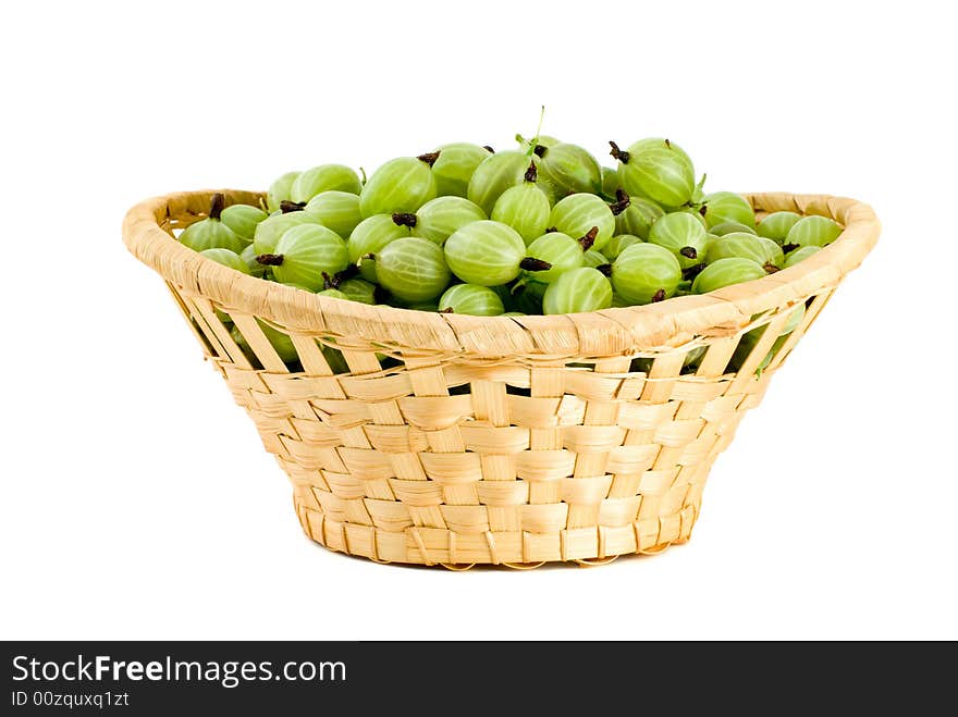 Wicker basket filled with green gooseberries